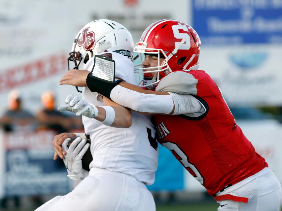 Caden Sheridan makes a touchdown-saving tackle on Cam Barnhouse during Sheridan's 14-0 win against visiting John Glenn on Friday night at Paul Culver Jr. Stadium.