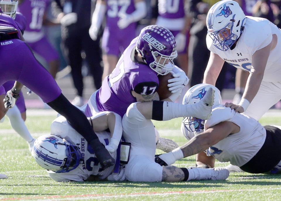 Mount Union defender Mason McMillen (17) recovers an Alfred State fumble during last week's playoff game.