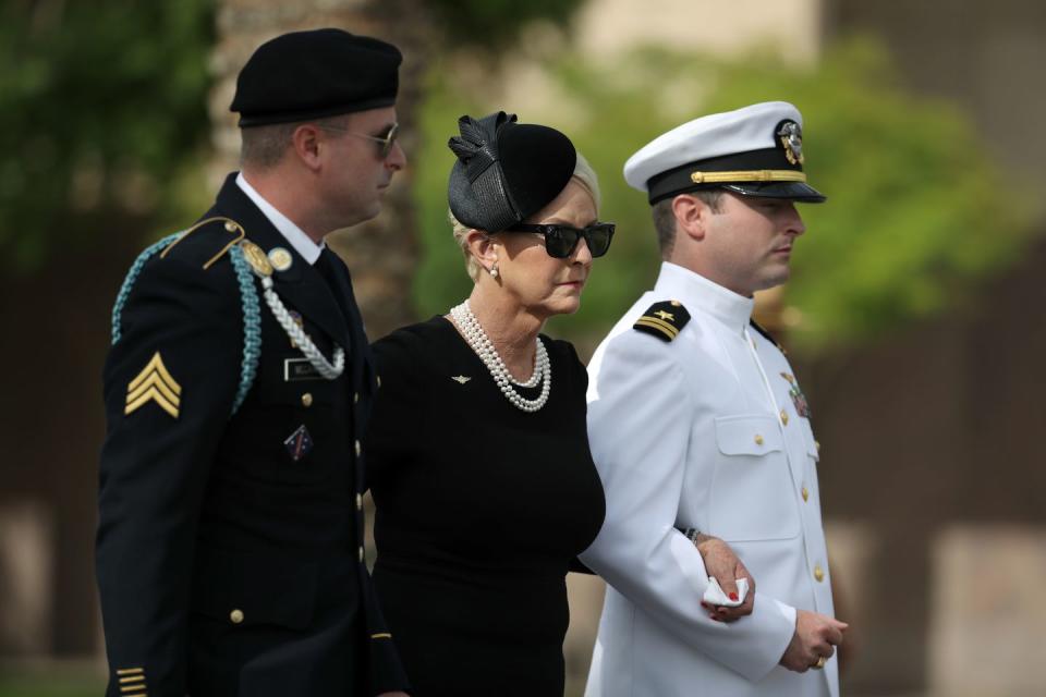 33) Jimmy and Jack McCain escort their mother into the memorial service in Phoenix