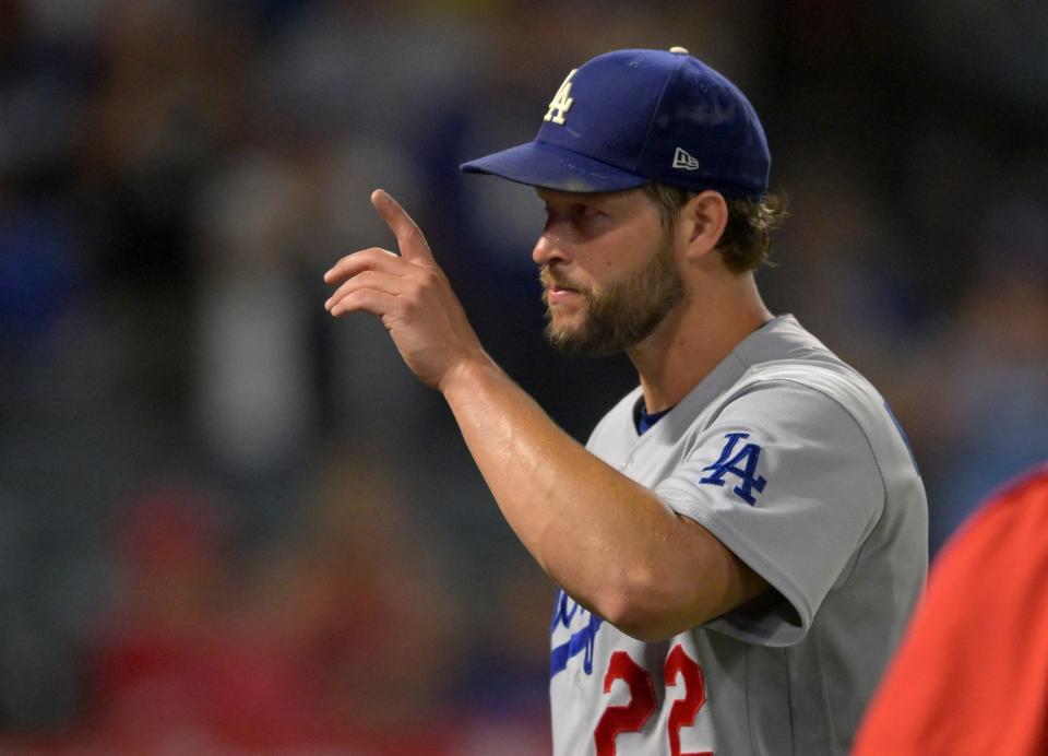 Los Angeles Dodgers starting pitcher Clayton Kershaw acknowledges the crowd as he leaves the field following the eighth inning at Angel Stadium.