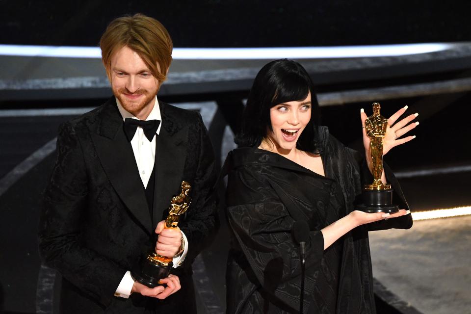 US singer-songwriter Finneas O'Connell (L) and US singer-songwriter Billie Eilish accept the award for Best Music (Original Song) for 