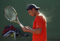 Spain's Rafael Nadal practices during a training session at Manacor tennis club on the Spanish Balearic island of Mallorca, January 30, 2013. Nadal is keeping his expectations low ahead of his long-awaited return to competitive action in early February after seven months out of tennis with a knee injury. The 26-year-old French Open champion has not played since losing to Czech Lukas Rosol in the second round at Wimbledon in June due to a partial tear of the patella tendon and inflammation in his left knee. REUTERS/Enrique Calvo (SPAIN - Tags: SPORT TENNIS TPX IMAGES OF THE DAY) - RTR3D5N9