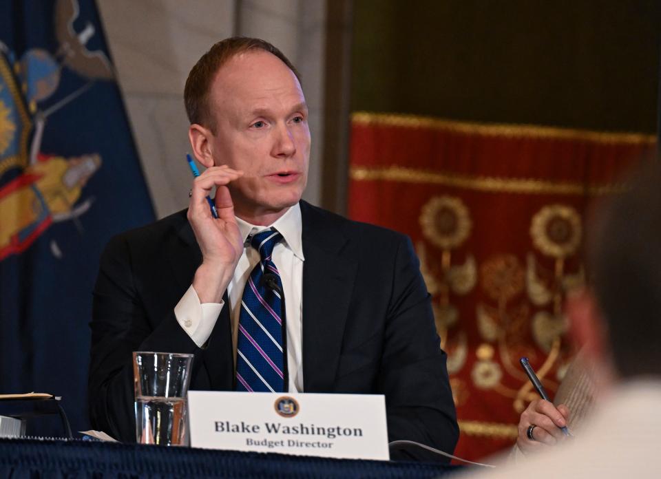 Blake Washington budget director of the State of New York, listens to New York Gov. Kathy Hochul's presentation on of her 2025 executive state budget in the Red Room at the state Capitol Tuesday, Jan. 16, 2024, in Albany, N.Y. (AP Photo/Hans Pennink)