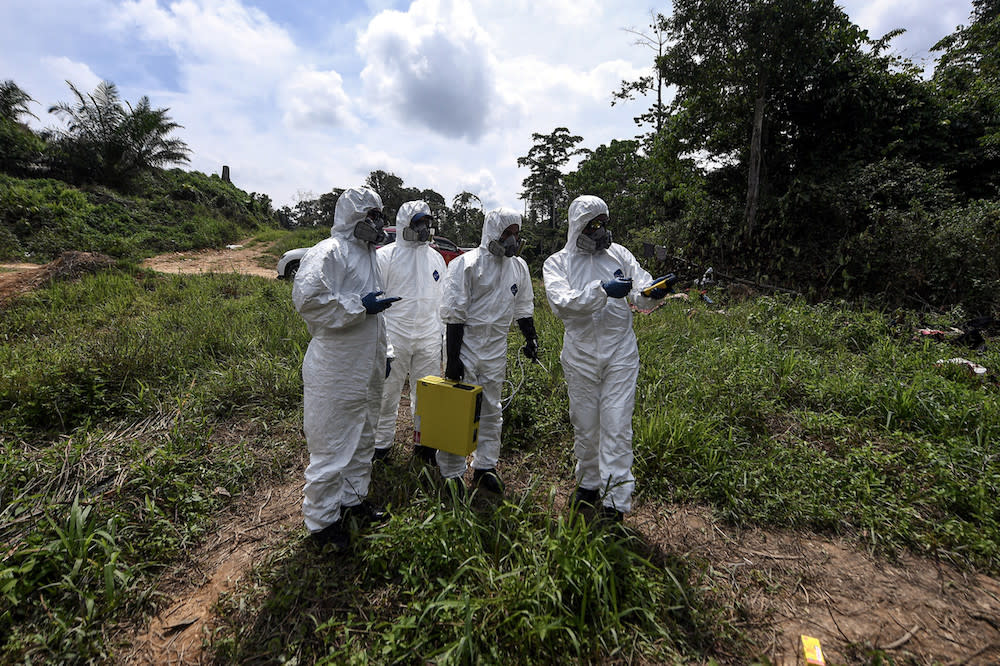 Hazmat personnel from the Kelantan Fire and Rescue Department collect air samples at the Kuala Koh Orang Asli settlement in Gua Musang June 11, 2019. — Bernama pic