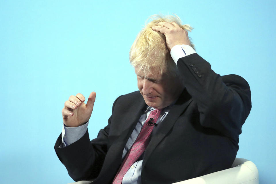 Conservative Party leadership candidate Boris Johnson gestures, during a Conservative leadership hustings in Maidstone, England, Thursday July 11, 2019. (Gareth Fuller/PA via AP)