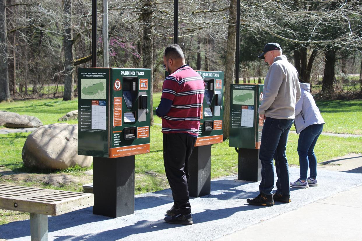 Visitors use automated fee machines to pay for parking.