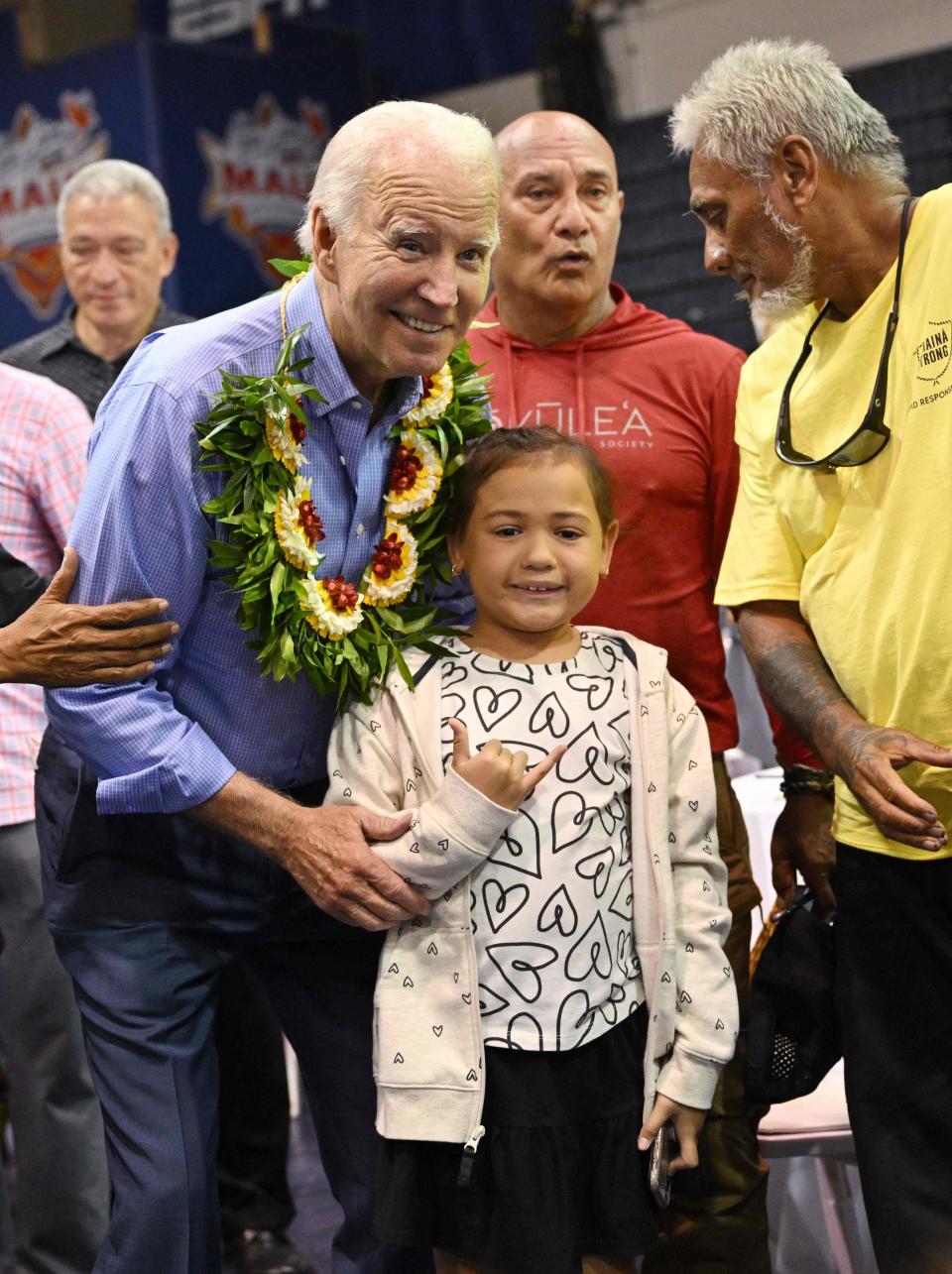 President Joe Biden poses for photos after speaking during a community engagement event at the Lahaina Civic Center in Lahaina, Hawaii on August 21, 2023.