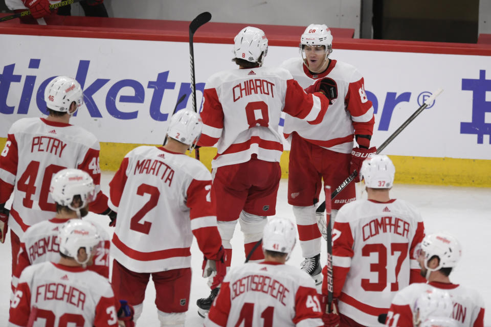 Detroit Red Wings' Patrick Kane (88) celebrates with teammate Ben Chiarot (8) after scoring the winning goal against Chicago Blackhawks goalie Petr Mrazek (34) to win 3-2 in overtime in an NHL hockey game, Sunday, Feb. 25, 2024, in Chicago. (AP Photo/Paul Beaty)