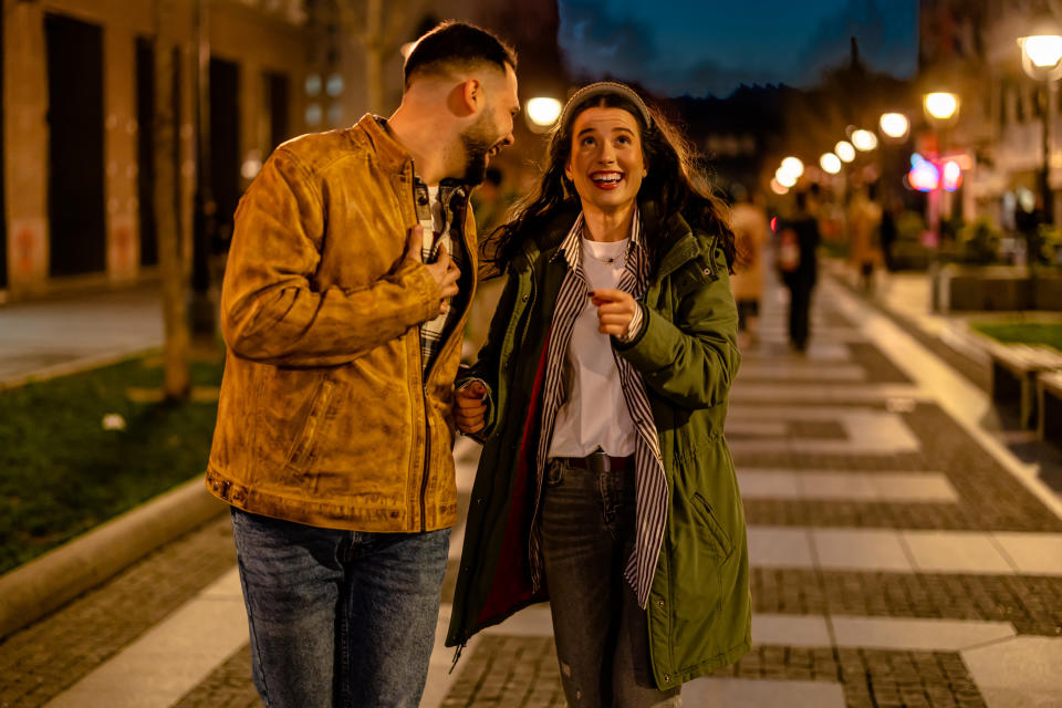 Couple takes a peaceful walk together on a quiet night street