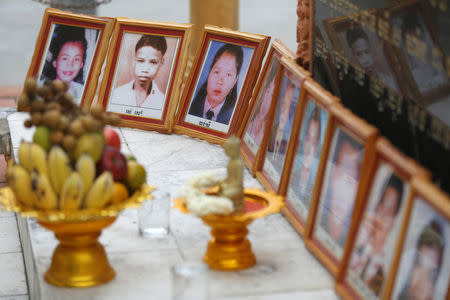 Portraits of victims of a fatal 1997 grenade attack on an opposition rally are displayed during a ceremony to remember the victims at a monument in Phnom Penh, Cambodia, March 30, 2018. REUTERS/Samrang Pring