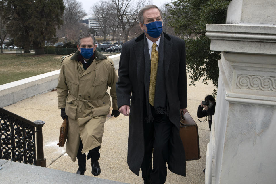 Bruce Castor, left, and Michael van der Veen, lawyers for former President Donald Trump, arrive at the Capitol on the fourth day of the second impeachment trial of Trump in the Senate, Friday, Feb. 12, 2021, in Washington. (AP Photo/Jose Luis Magana)