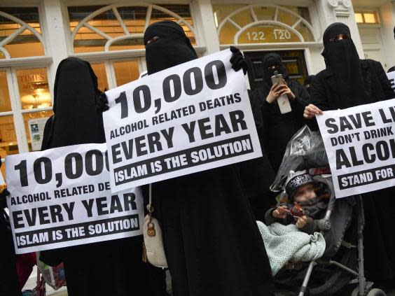 Al-Muhajiroun supporters at a 2013 protest organised by Anjem Choudary under the name the ‘Shariah Project’ in Brick Lane, London (Reuters)