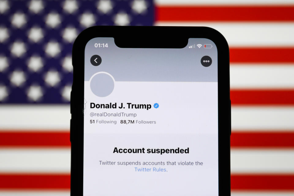 Donald Trump's Twitter account displayed on a phone screen and American flag in the background are seen in this illustration photo taken in Poland on January 9, 2021. Twitter suspended Donald Trump's account because of violating the app rules. (Photo by Jakub Porzycki/NurPhoto via Getty Images)