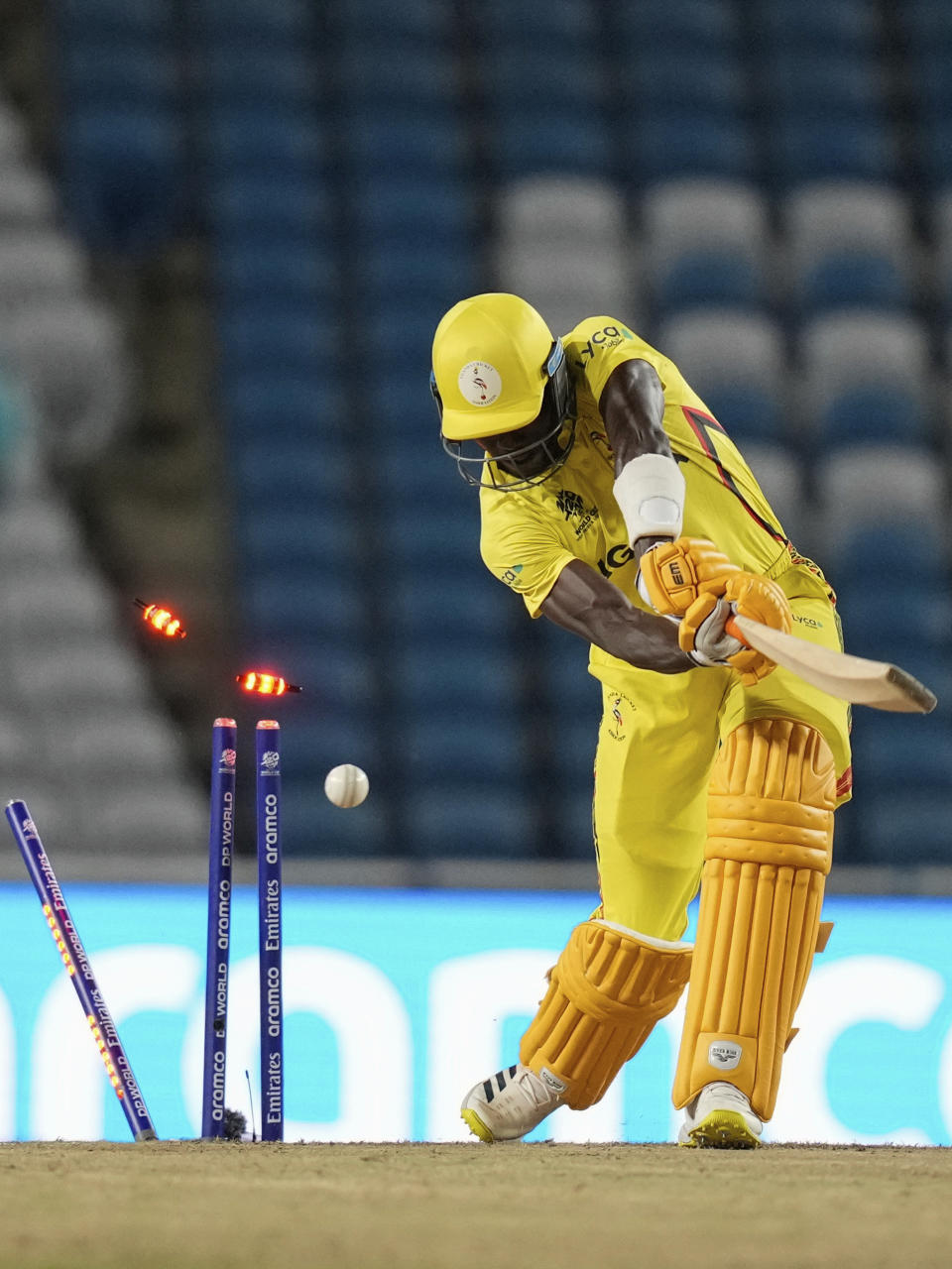 Uganda's Robinson Obuya is clean-bowled by New Zealand's Trent Boult for a duck during an ICC Men's T20 World Cup cricket match at the Brian Lara Cricket Academy in Tarouba, Trinidad and Tobago, Friday, June 14, 2024. (AP Photo/Ramon Espinosa)