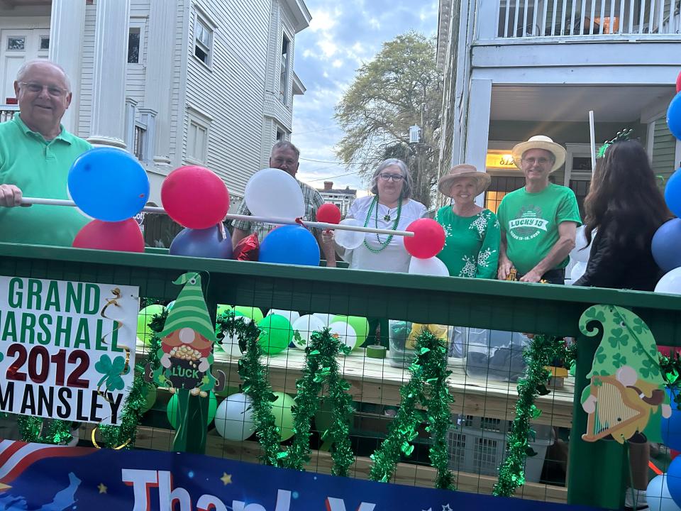 Members of the Ansley family are working hard to get the Ansley Family Float ready before the parade kicks off.