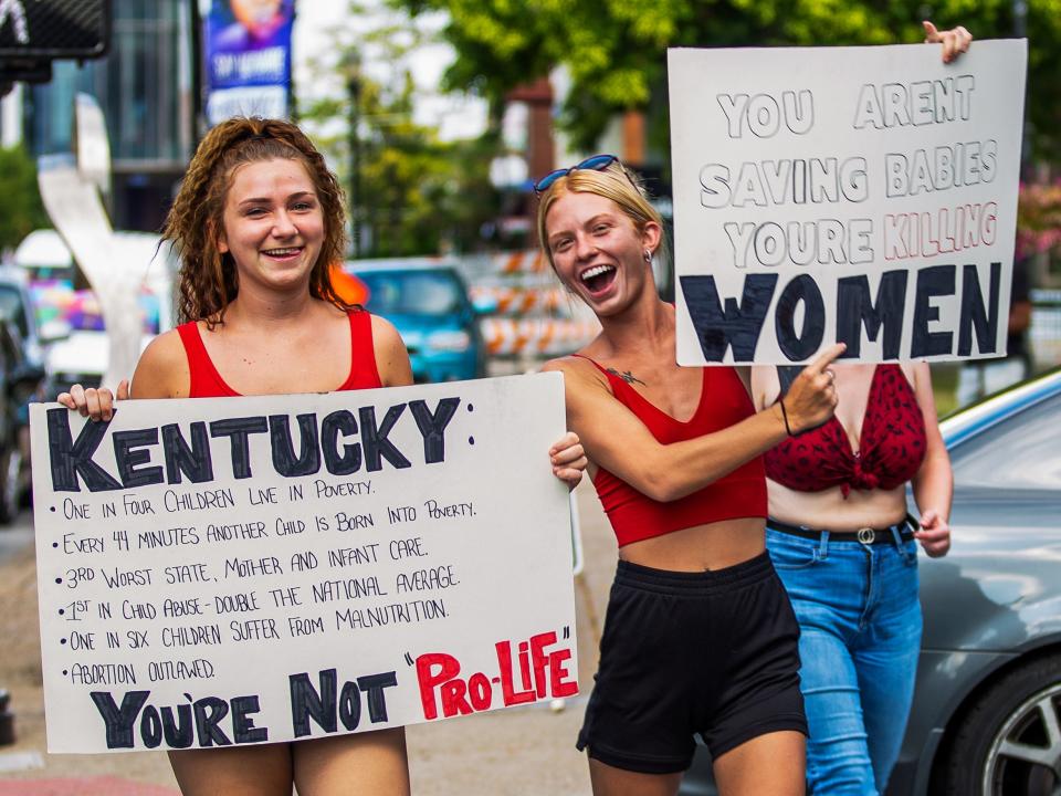 Women show their signs at Rally for Women's Rights, a gathering supporting pro-choice, at Louisville Metro Hall in downtown Louisville on July 4, 2022. This comes after the Supreme Court overturned Roe V. Wade. 