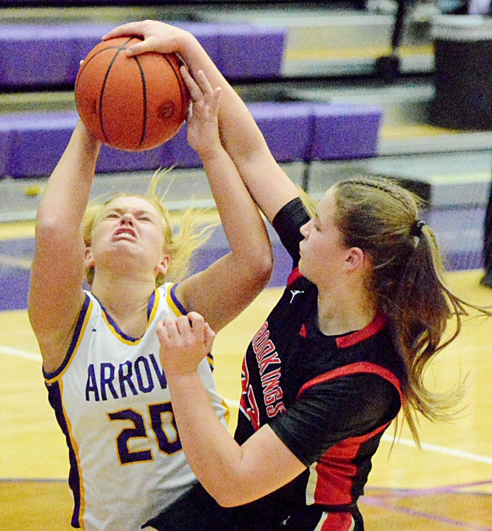 Watertown's Neely Johnson puts up a shot against Brookings' Logan Smidt during their season-opening high school girls basketball game Friday night in the Civic Arena. Smidt was called for a foul on the play.