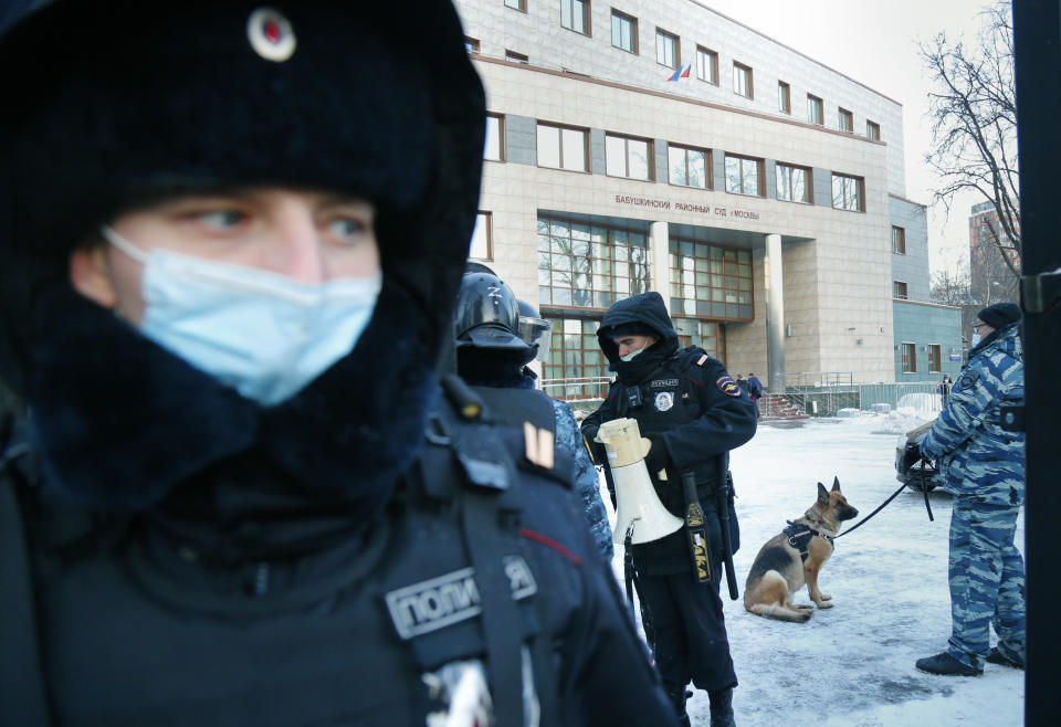 Policemen stand guard at the Babuskinsky district court prior to the continuation of the trial against Russian opposition leader Alexey Navalny in Moscow, Russia, Friday, Feb. 5, 2021. Navalny was accused of slandering a World War II veteran featured in the video promoting the constitutional reform allowing to extend President Vladimir Putin's rule. The politician slammed people in the video as "corrupt stooges" and "traitors." (AP Photo/Alexander Zemlianichenko)