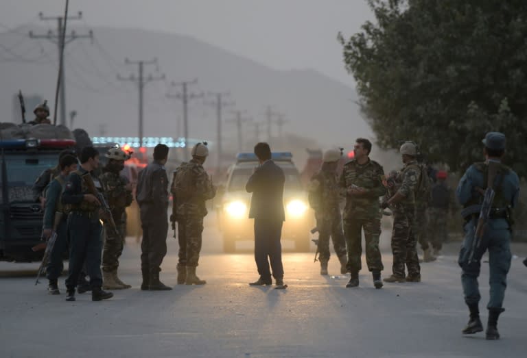 Afghan security personnel gather as they keep watch near the site of a suicide bomb attack near the Marshal Fahim military academy base in Kabul on October 21, 2017