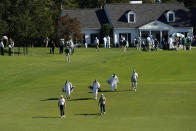 Golfers and caddies walk up the first fairway during the second round of the Masters golf tournament Friday, Nov. 13, 2020, in Augusta, Ga. (AP Photo/Matt Slocum)