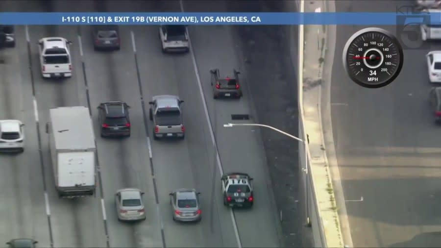 LAPD officers began a ground pursuit of the suspect on the 110 Freeway. The driver of the allegedly stolen vehicle surrounded near the Vernon Avenue underpass on April 19, 2024. (KTLA)