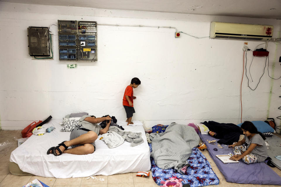 People take cover inside a bomb shelter in Ashkelon, Israel, on Sunday. (Ronen Zvulun/Reuters)