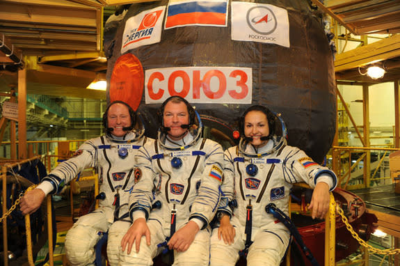 NASA astronaut Barry "Butch" Wilmore (left) and Russian cosmonauts Alexander Samokutyaev (center) and Elena Serova pose with their Soyuz TMA-14M spacecraft ahead of a September 2014 launch to the International Space Station.