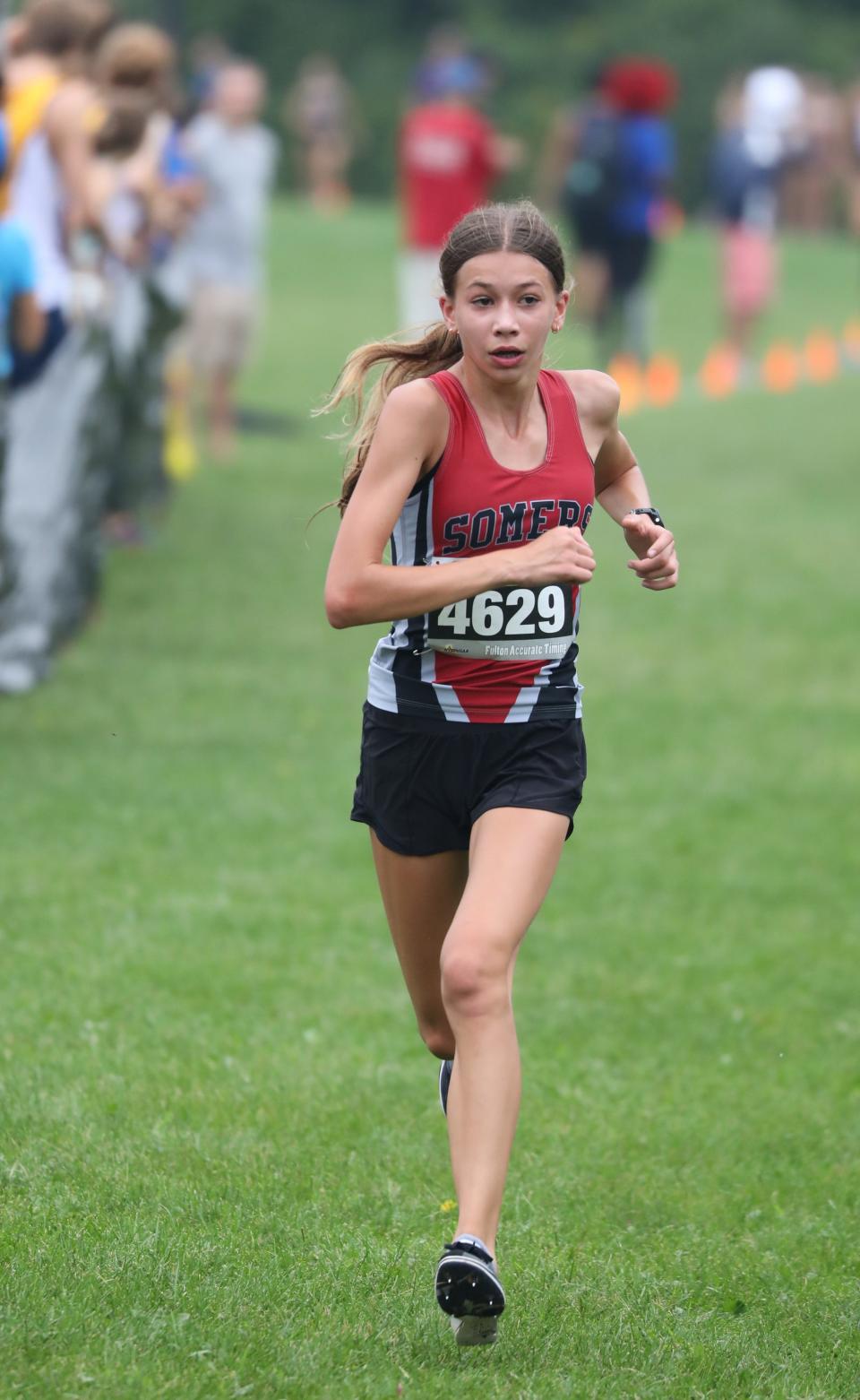 Julia Duzynski from Somers crosses the finish line during the girls D2 race at the Somers Big Red Invitational Cross Country meet at Somers High School, Sept. 9, 2023.