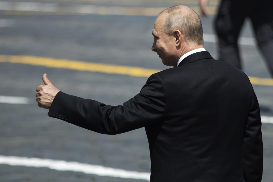 Russian President Vladimir Putin gestures as he leaves Red Square after the Victory Day military parade marking the 75th anniversary of the Nazi defeat in Moscow, Russia, Wednesday, June 24, 2020. Russian President Vladimir Putin hailed the defeat of Nazi Germany at the traditional massive Red Square military parade, which was delayed by more than a month because of the invisible enemy of the coronavirus. The parade is usually held May 9 on Victory Day, Russia's most important secular holiday but was postponed until Wednesday due to the pandemic. (AP Photo/Pavel Golovkin, Pool)