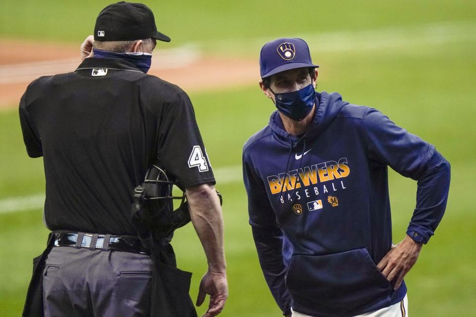 FILE - In this Monday, Sept. 14, 2020, file photo, Milwaukee Brewers manager Craig Counsell talks to umpire Ron Kulpa during the first inning of the first game of a baseball doubleheader against the St. Louis Cardinals, in Milwaukee. Counsell is confident former MVP Christian Yelich’s 2020 hitting struggles won’t carry over into next season. (AP Photo/Morry Gash, File)