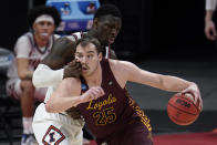 Loyola Chicago center Cameron Krutwig (25) drives on Illinois center Kofi Cockburn (21) during the first half of a men's college basketball game in the second round of the NCAA tournament at Bankers Life Fieldhouse in Indianapolis, Sunday, March 21, 2021. (AP Photo/Paul Sancya)