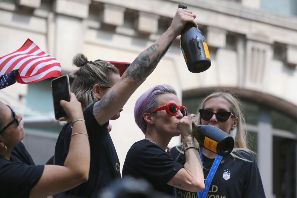 Megan Rapinoe takes a drink of the bubbly as the U.S. women's soccer team is celebrated with a parade along the Canyon of Heroes, Wednesday, July 10, 2019, in New York. (Photo: Gordon Donovan/Yahoo News)