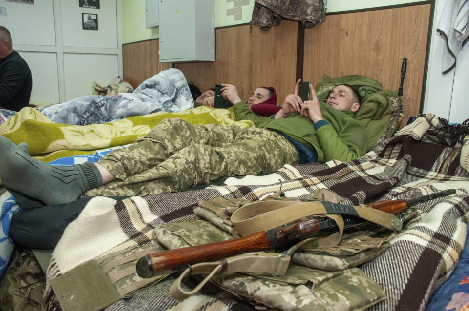 Ukrainian servicemen have a rest in Kharkiv, Ukraine, Tuesday, March 22, 2022. (AP Photo/Andrew Marienko)