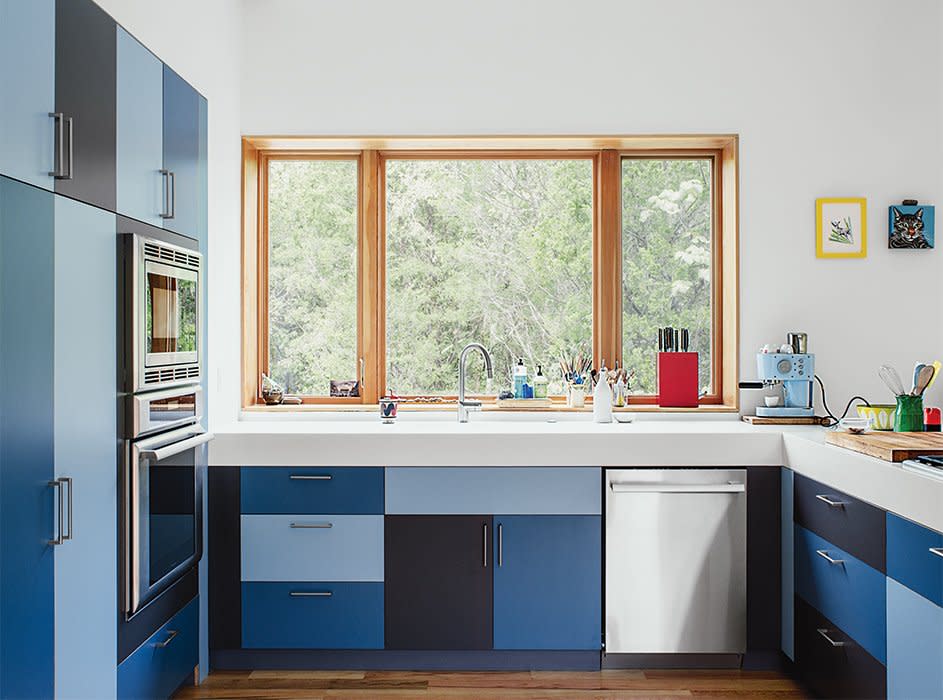 Here, laminate kitchen cabinets are topped with Corian in Glacier White for a fresh and fun color-blocked look.