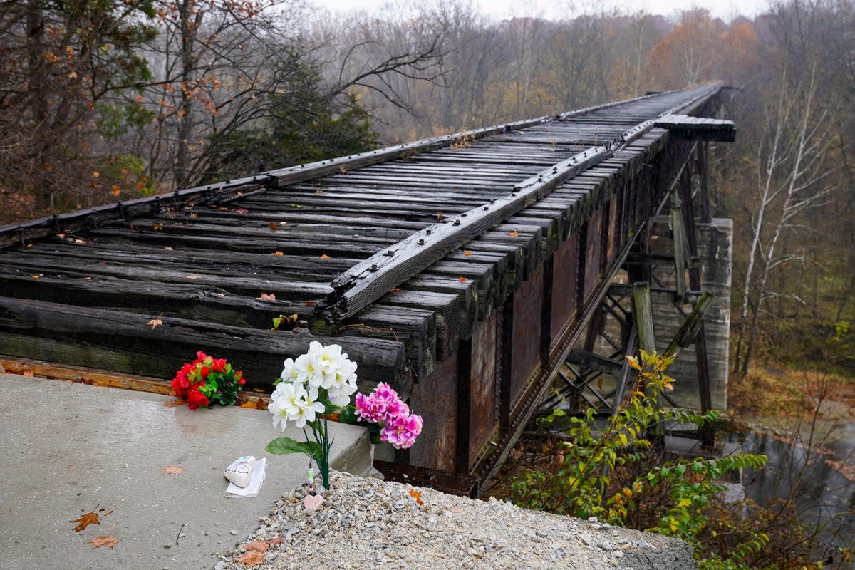 Flowers at the Monon High Bridge in memory of Libby and Abby (Copyright 2022 The Associated Press. All rights reserved.)