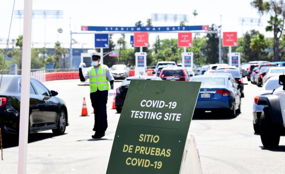 Traffic is directed at Dodger Stadium as people arrive for COVID-19 testing on June 30, 2020 in Los Angeles, California. (Frederic J. Brown/AFP via Getty Images)