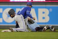 Minnesota Twins' Byron Buxton, left, steals second base, beating the tag attempt by Toronto Blue Jays second baseman Marcus Semien in the fifth inning of a baseball game, Saturday, Sept. 25, 2021, in Minneapolis. (AP Photo/Jim Mone)