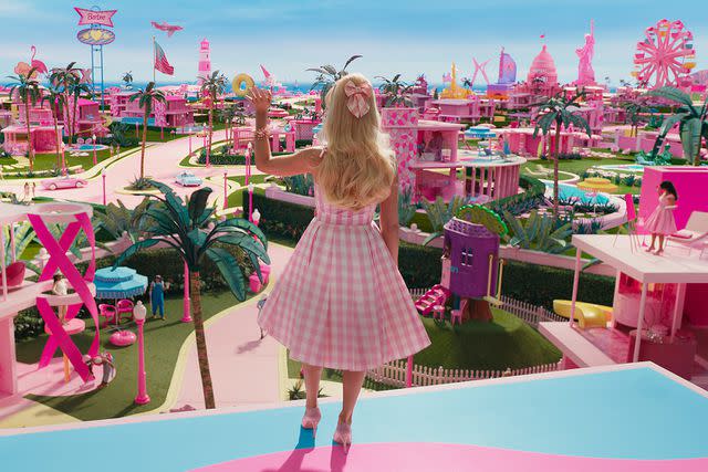 <p>Courtesy Warner Bros. Pictures</p> Margot Robbie looks out over Barbie Land in the 'Barbie' movie.