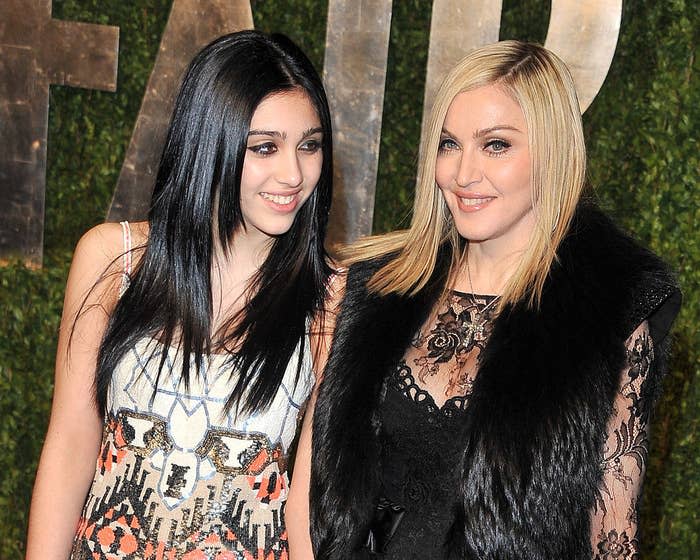 Lourdes and Madonna posing for photos at an event