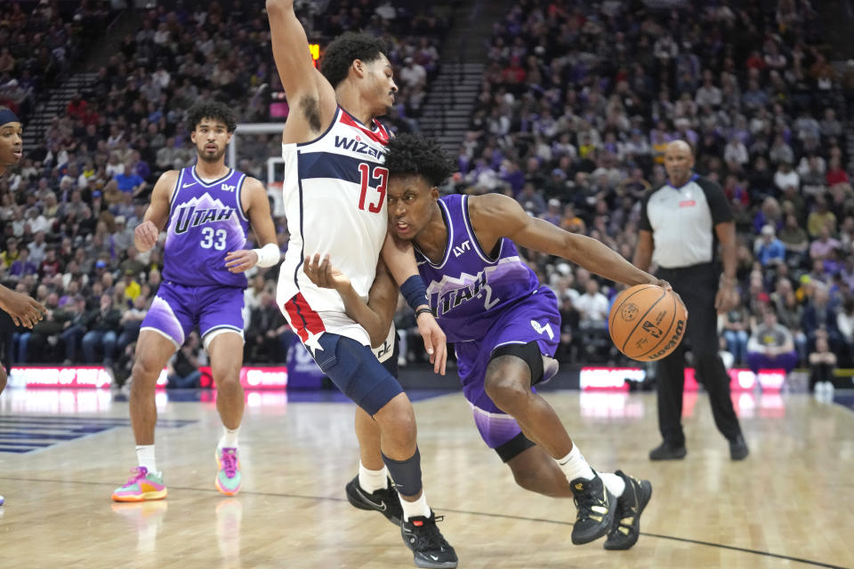 Washington Wizards guard Jordan Poole (13) fouls Utah Jazz guard Collin Sexton (2) who drives with the ball during the second half of an NBA basketball game Monday, March 4, 2024, in Salt Lake City. (AP Photo/Rick Bowmer)