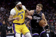 Sacramento Kings forward Domantas Sabonis (10) drives to the basket against Los Angeles Lakers forward Anthony Davis (3) during the second half of an NBA basketball game in Sacramento, Calif, Wednesday, March 13, 2024. (AP Photo/Jed Jacobsohn)