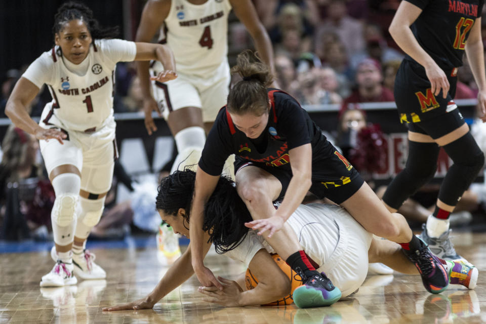South Carolina's Brea Beal, on floor, tries to keep the ball while Maryland's Abby Meyers lunges for the ball in the first half of an Elite 8 college basketball game of the NCAA Tournament in Greenville, S.C., Monday, March 27, 2023. (AP Photo/Mic Smith)