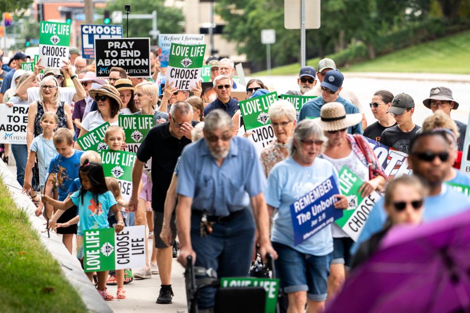 Marchers participate in the Iowa March For Life on the Iowa Capitol grounds Saturday.