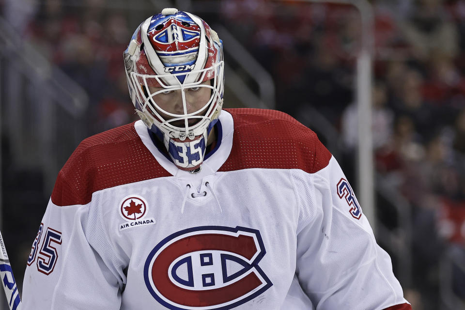 Montreal Canadiens goaltender Sam Montembeault pauses during a break in play against the New Jersey Devils during the second period of an NHL hockey game Wednesday, Jan. 17, 2024, in Newark, N.J. (AP Photo/Adam Hunger)