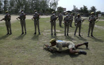 Special police officer recruits who completed nearly three months physical training demonstrate their skills at Kathua in Indian-controlled Kashmir, Saturday, June 5, 2021. Special police officers are lower-ranked police officials who are mainly recruited for intelligence gathering and counterinsurgency operations. In recent years, the force has assisted in border areas as well because of local recruits' familiarity with the topography and ability to assist police and border guards during emergencies. (AP Photo/Channi Anand)