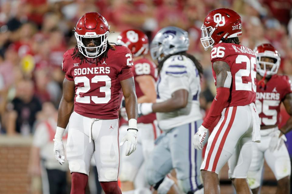 OU's DaShaun White (23) and Kani Walker (26) walk away after a Kansas State touchdown during the Wildcats' 41-34 win Saturday night in Norman.