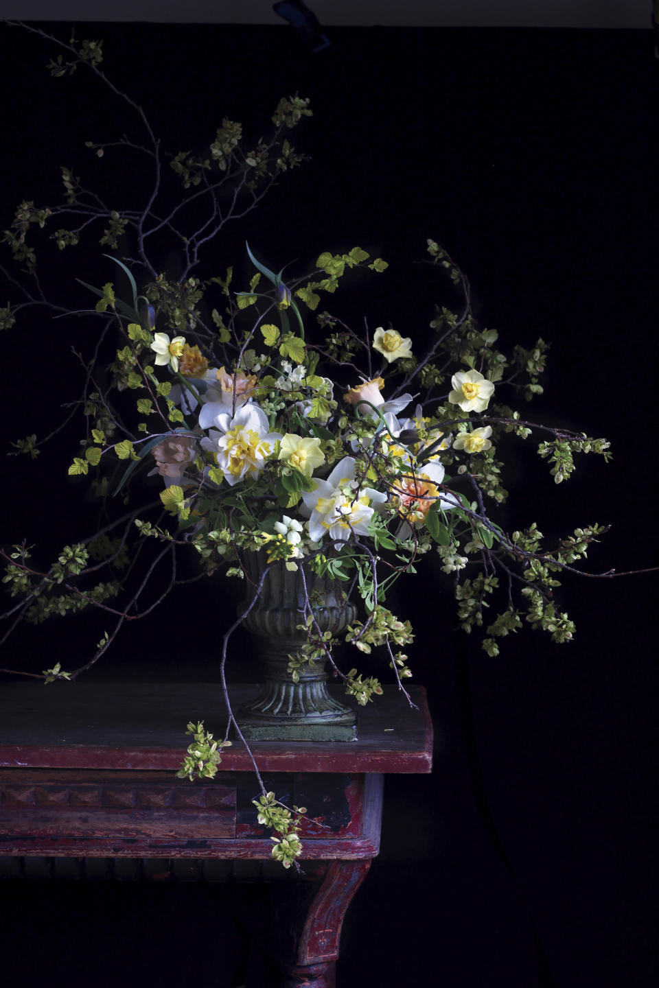 This photo shows a floral display featured in the book "Cultivated: The Elements of Floral Style" by Christin Geall. In lighting fixtures, wallpapers, bedding and wall art, floral design is having a big year in 2020. There's also a renewed interest in flower arranging and floral-inspired table settings. (Christin Geall/Princeton Architectural Press via AP)