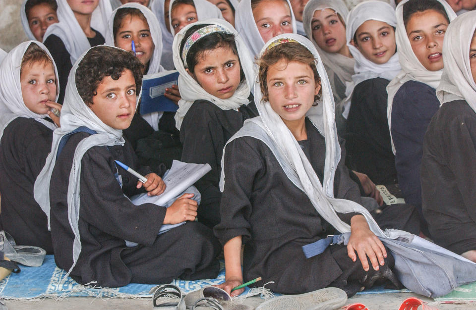 a group of young children with head wear