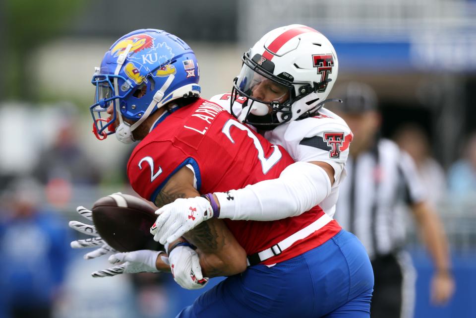 Kansas wide receiver Lawrence Arnold (2) makes a catch as Texas Tech defensive back Bralyn Lux (12) defends during a Big 12 Conference football game Nov. 11, 2023, at David Booth Kansas Memorial Stadium in Lawrence, Kansas.