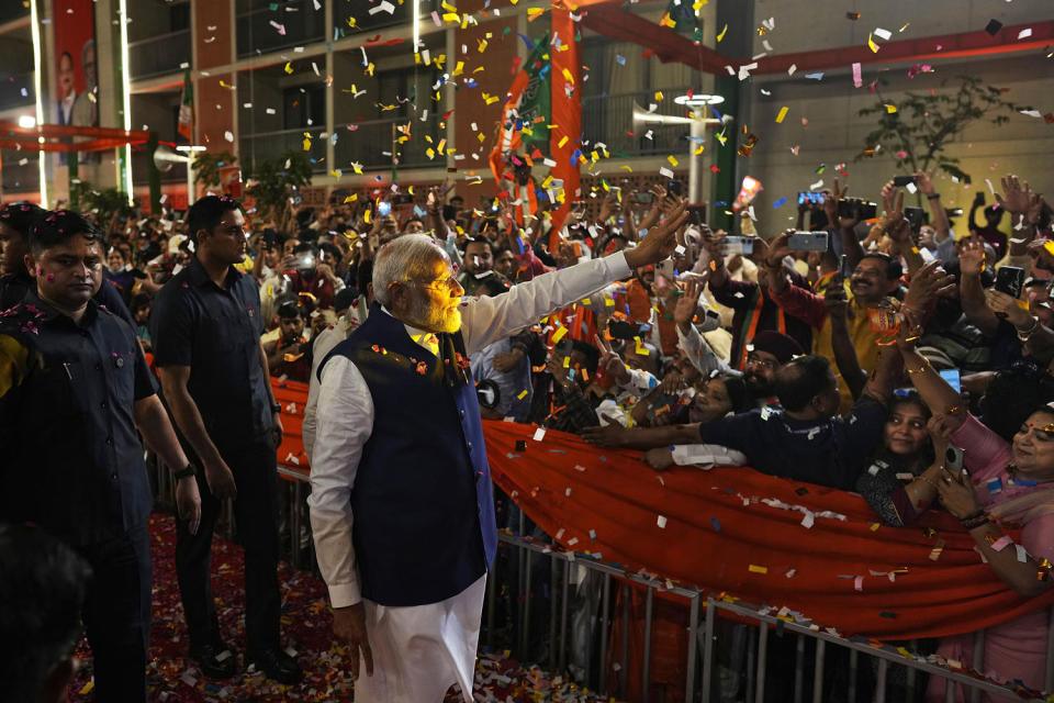 Narendra Modi greets supporters in New Delhi (Manish Swarup / AP)